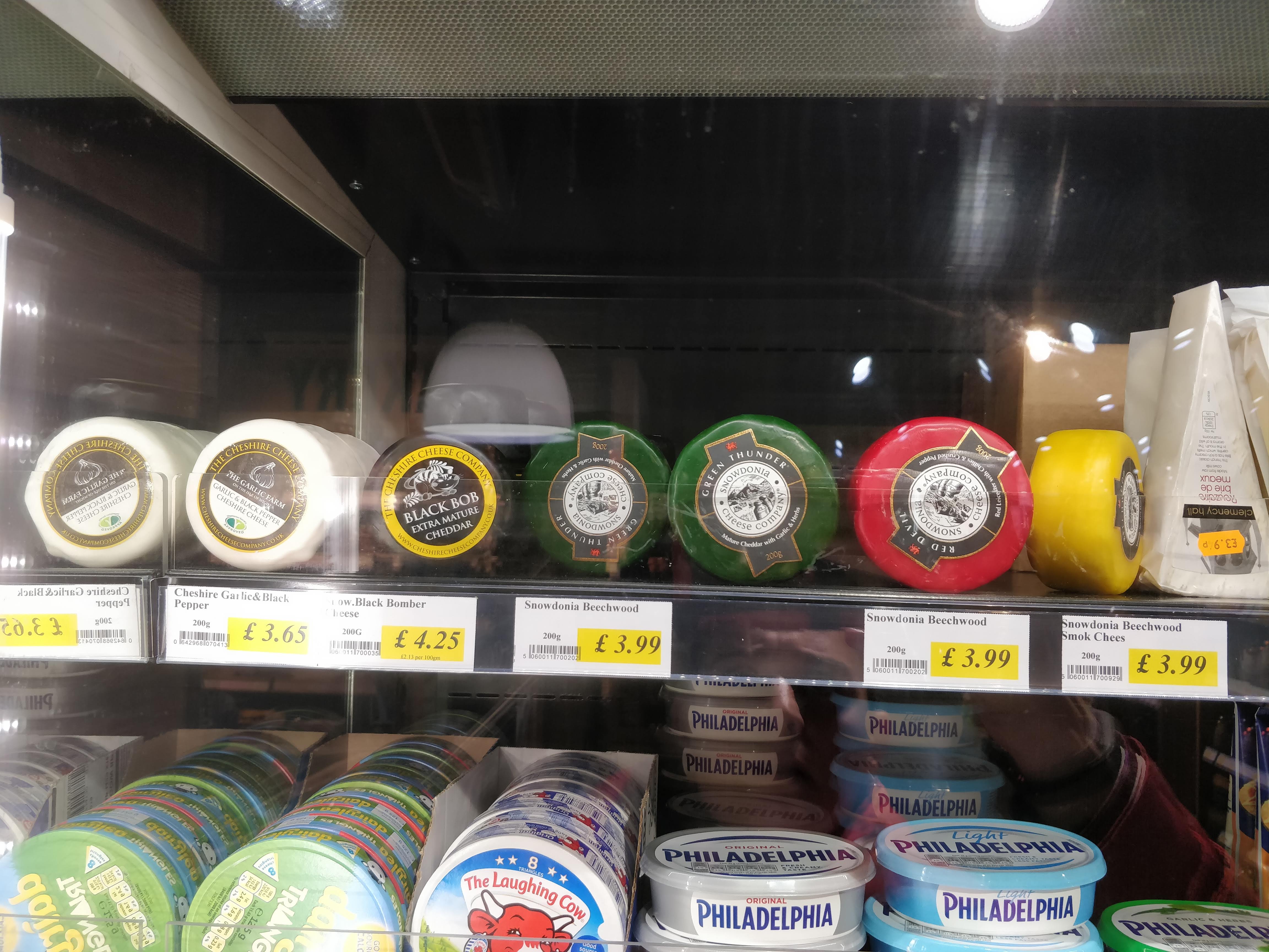 Selection of cheeses in wax at Jay's Budgens